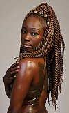 Exotic dark skinned beauty with amazing hair stands naked